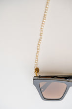 Load image into Gallery viewer, Freshwater pearl chain from BRAND. The Label. pictured as a sunglass chain to keep your eyewear safe. From BRAND. The Label resort wear collection. 
