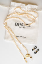 Load image into Gallery viewer, Freshwater pearl chain by BRAND. The Label to be used at a frame chain, sunglass chain or jewellery. Pictured in ivory with gold tone hardware. 
