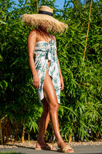 Load image into Gallery viewer, BRAND The Label - Lux Sarong in Palm print here wrapped around the chest for a stylish beach cover up look 
